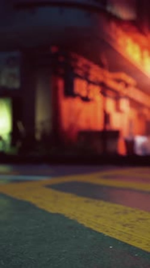 A Bustling City Street Illuminated By Neon Lights at Night