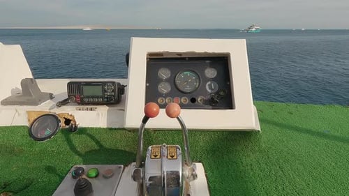 Steering Wheel and Navigation Compass on a Yacht Background of Red Sea. The Concept of Vacation or T