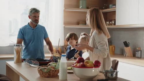 Caucasian Family with Little Kids Prepare Together Healthy Vegetable Salad in the Kitchen at Home