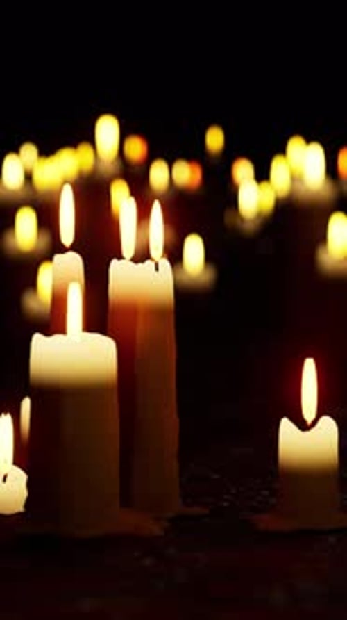 Flickering Candles in Dark Vertical Background