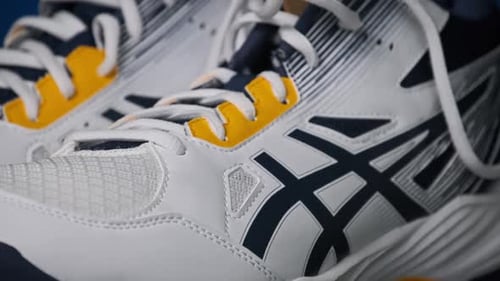 Close Up of White, Black, and Yellow Athletic Shoes