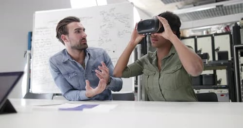 Colleagues discuss virtual reality in an office setting