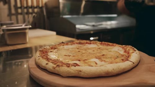 Chef Brushing Olive Oil on Gourmet Cheese Pizza