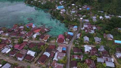 Aerial view of coastal village near road, Indonesia.