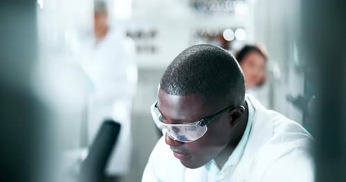 Focused Scientist Working in Bright Modern Laboratory