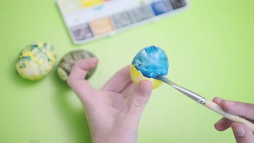 Easter Holidays Traditions and People Concept Close Up of Boy's Hands Coloring Easter Eggs with