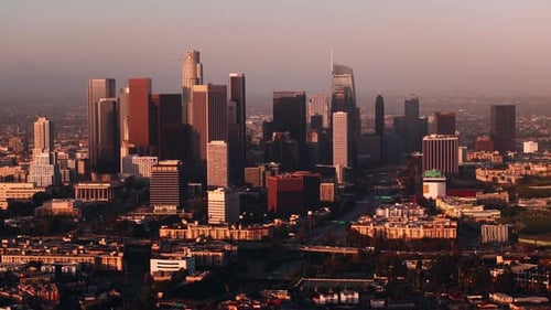 Drone view of traffic and skyscrapers in Downtown Los Angeles during sunrise