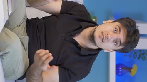 Vertical video of The man who is angry at the camera.