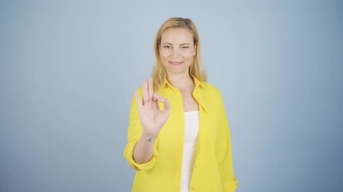 Woman giving perfect expression looking at camera happy and satisfied.