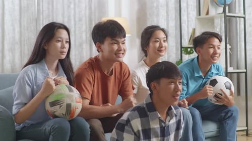 Excited Friends Cheering for Soccer Team at Home