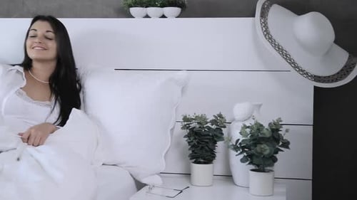 Woman Wakes Up and Puts On Glasses