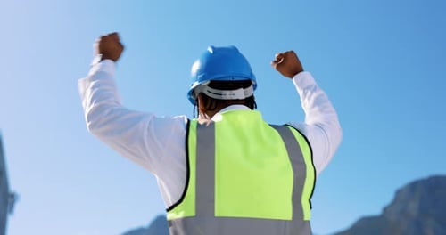 Construction Worker Celebrating Success in Sunny Location