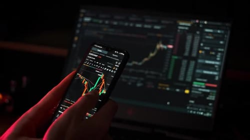 Crypto Businessman Working with Stock Market Data Graph on a Smartphone