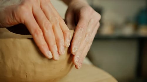 Creating handicraft pottery closeup of working table in ceramics studio with female master