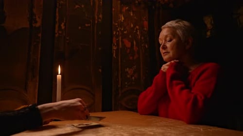 Woman Receives Tarot Card Reading by Candlelight