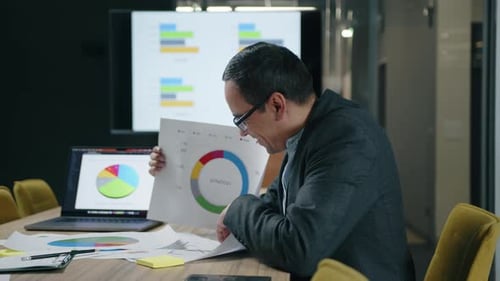 Closeup of Financial Expert Showing Annual Results in a Conference