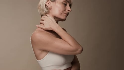 Blonde Woman Massaging Neck Muscles