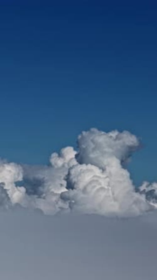 Rise above the cloud so high, peaceful flight in a bright blue sky
