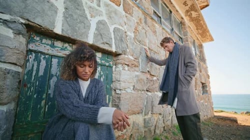 Sad Man Woman Contemplating at Beachside Zoom Out Upset Two People at Castle