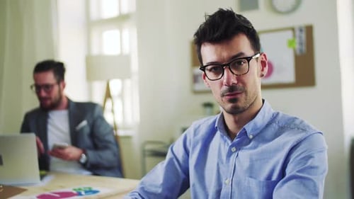 Young businessman collaborating with colleagues in a bright modern office