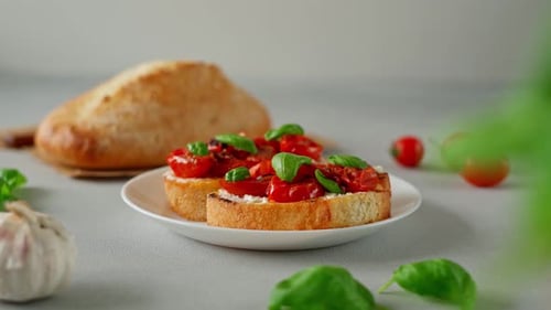 Bruschetta with Ricotto cheese and cherry Tomatoes, basil, garlic on a grey concrete background