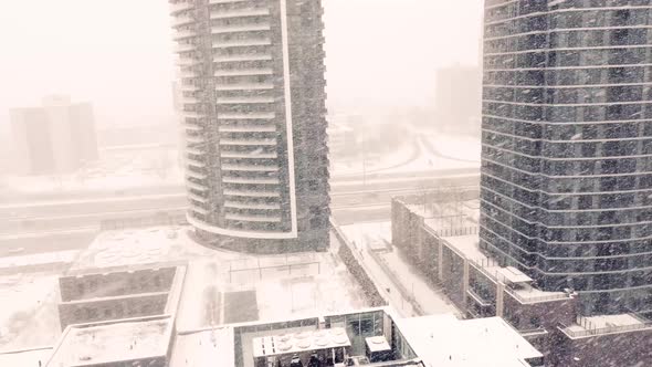High rise commercial buildings during a snow storm. In the background ...