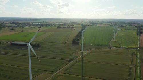 Aerial View of Windmills Standing in a Field on a Sunny Summer Day