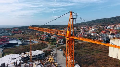 Footage at the top of the crane. New design building construction site below.