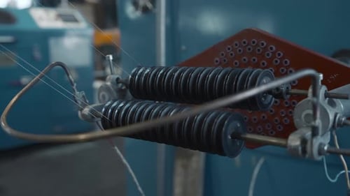 Coil winder machine with copper wire. Creative. Copper round rollers for rolling wire at the factory