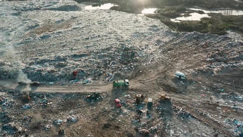 Aerial View of Garbage Truck Driving at Landfill Dump of Unsorted Waste Garbage Pile in Trash Dump