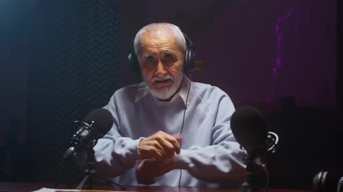 The Old Man Creates a Podcast in a Professional Studio Senior Male Does Online Streaming Interviews