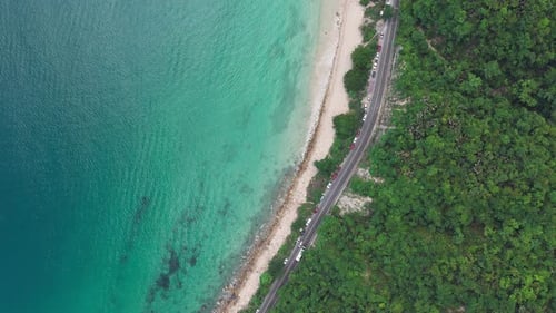 Cenital angle of the highway south of Puerto Vallarta, passing by a beach with crystal clear waters