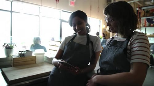 Female Cafe Workers Using Smart Phone 2529 Years