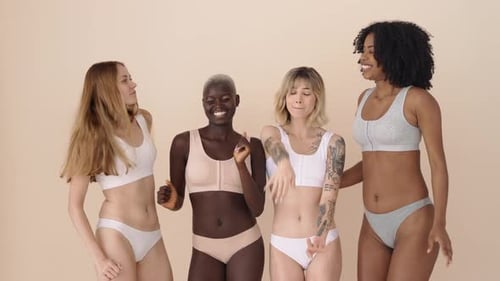 Smiling Women Dancing Together in Underwear and Bralettes