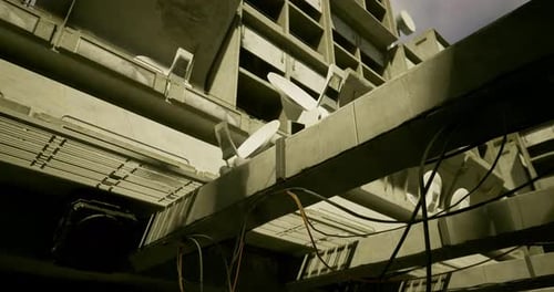 Exploring Abandoned Urban Structures with Visible Wiring and Satellite Dishes