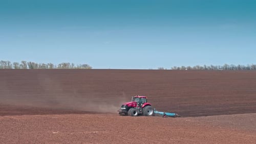 Tractor Driving And Plowing A Field Aerial
