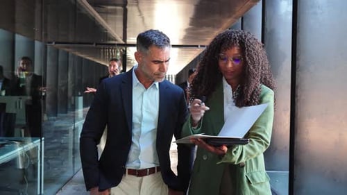 Business People Discussing Documents in Modern Office