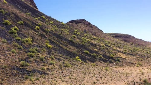 Aerial pan along the base of a desert mountain, Scottsdale, Arizona. Concept: desert,mountains,trav