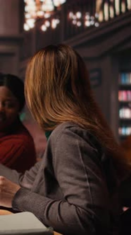 Vertical Video Mature Woman Student in the Library Highlighting Important Ideas for Exams