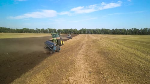 Tractors plowing the field in Ukraine