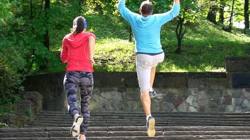 Active Young Couple Race, Jogging Up the Stairs in City, Super Slow