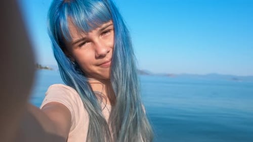 Girl with Blue Hair Smiling on the Beach