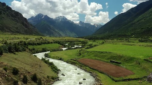 Aerial View of River Flowing Through Mountain Valley