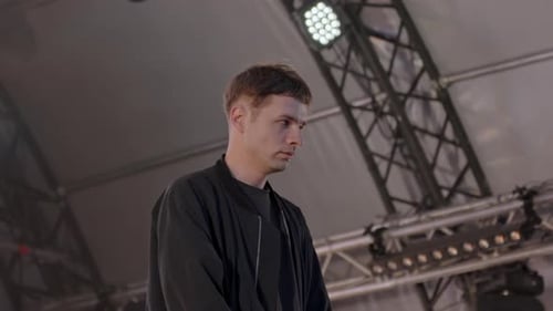 Male Musician Performing on Dimly Lit Stage