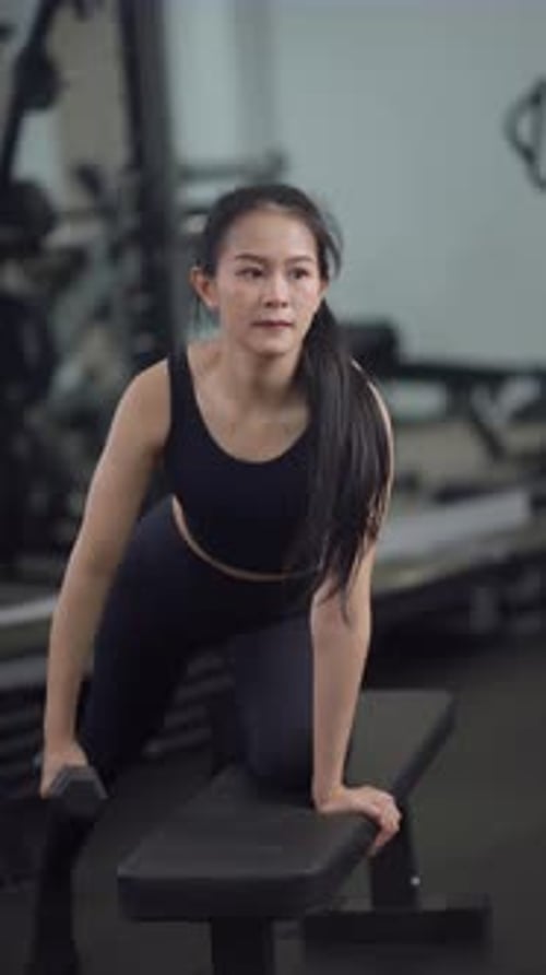 Asian woman exercising with a dumbbell