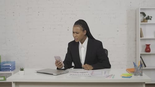 Professional Woman on Video Call in Bright Office