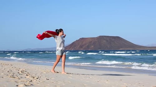 Young woman enjoying day at seaside on a empty beach