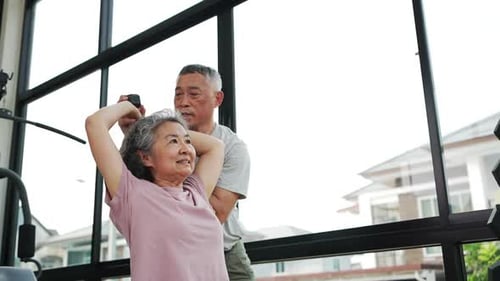 Senior Couple Stretching Together in Home Gym