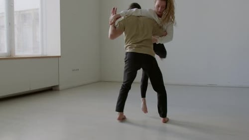 Couple Performing Contemporary Dance on Rehearsal in Studio