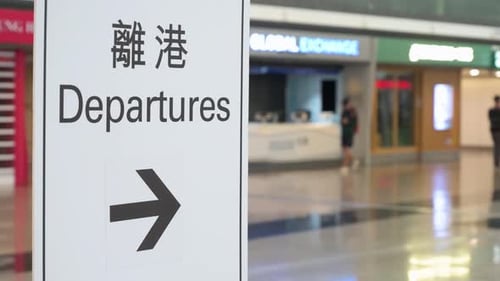 A sign with the word "Departures" indicates the location of the departure hall at Chek Lap Kok Inter